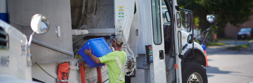 Person putting curbside recycling into truck