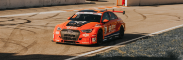 orange-audi-rs-3-racecar-at-a-racetrack