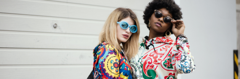 Two women posing in colourful prints