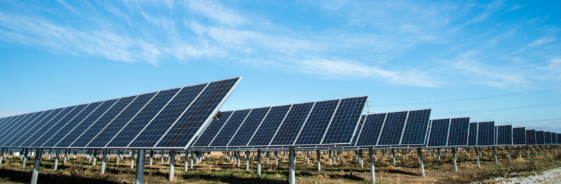 rows-of-solar-panels-against-blue-sky