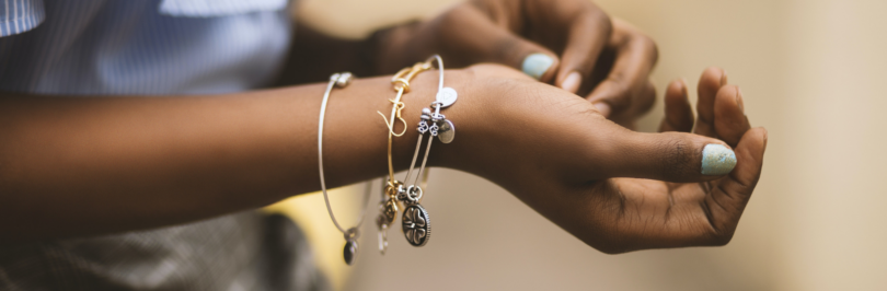 selective-focus-photography-of-person-wearing-three-bangles
