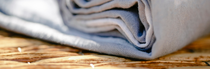 roll-of-fabric-on-wicker-table