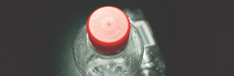 two-clear-plastic-bottles-on-black-surface