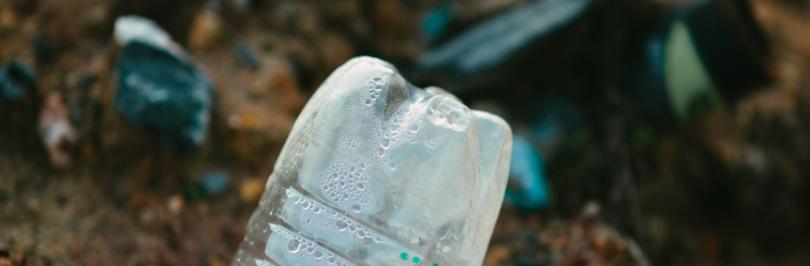 white-plastic-bottle-on-brown-soil