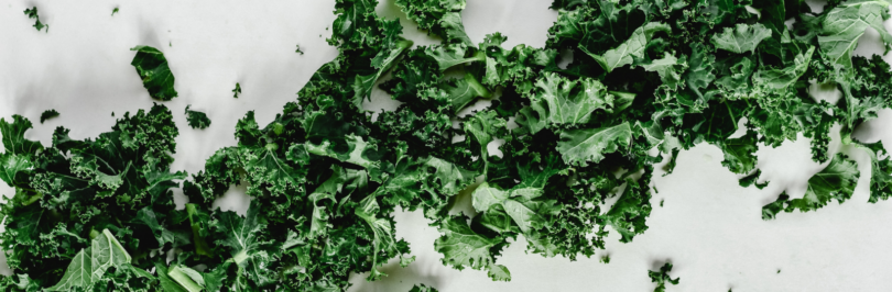 close-up-shot-of-chopped-kale-on-a-white-surface