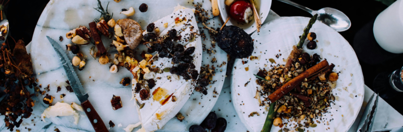 Dinner food waste on white plates with cutlery