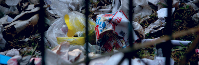 Garbage trapped behind a fence