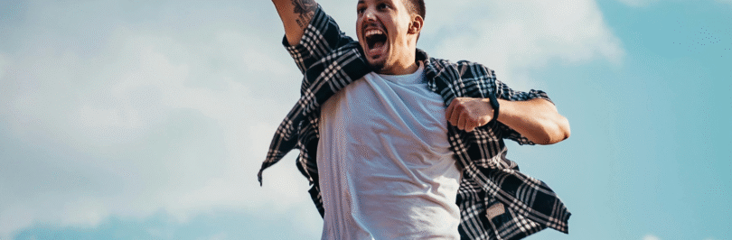 man in a t-shirt and shorts jumping in the air