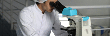 man looking into a microscope