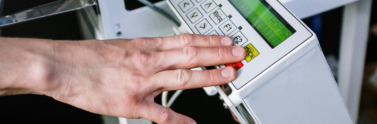 Man touching a keypad on a machine