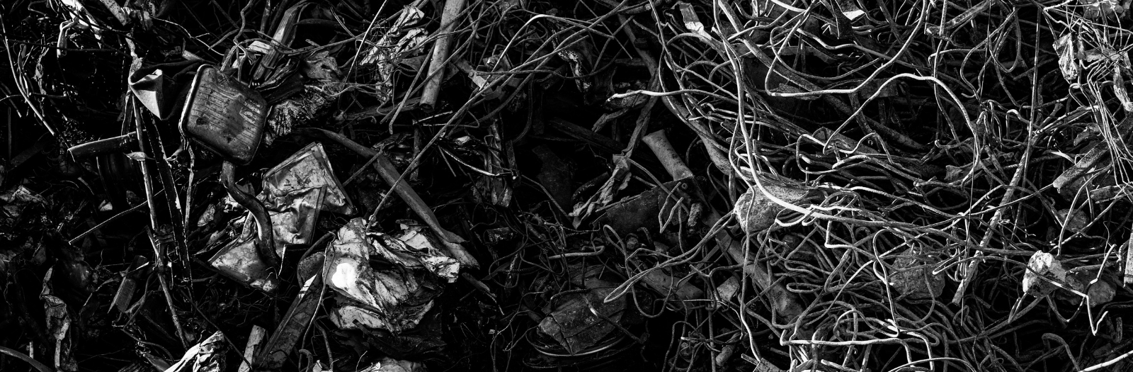 discarded metal wires on a black surface