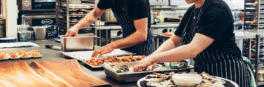 two people working in a restaurant kitchen