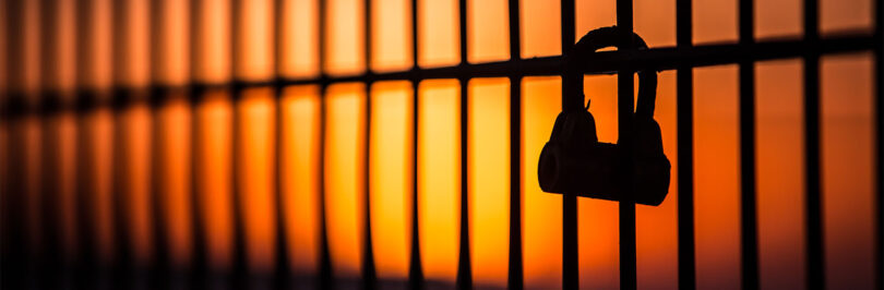 prison bars at sunset