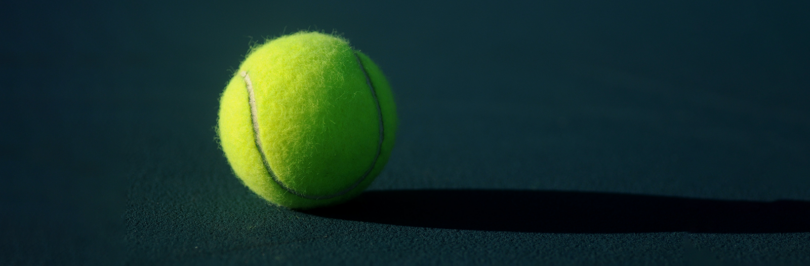 Yellow tennis ball on court
