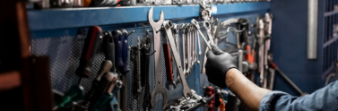 Person borrowing tool from tool wall