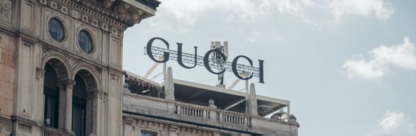 Gucci sign on top of old building in Italy