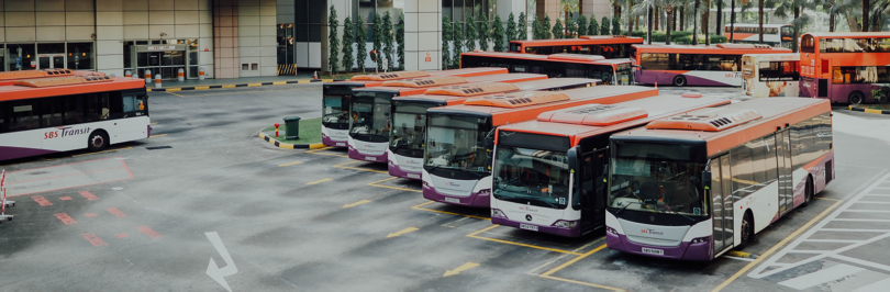 orange and white busses at transit depot