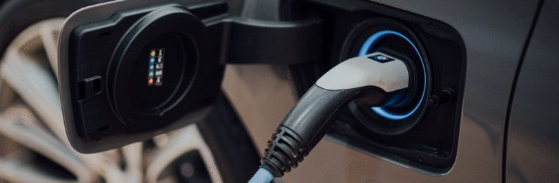 closeup photo of an electric vehicle being charged