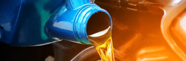 photo of a canister pouring oil into an engine
