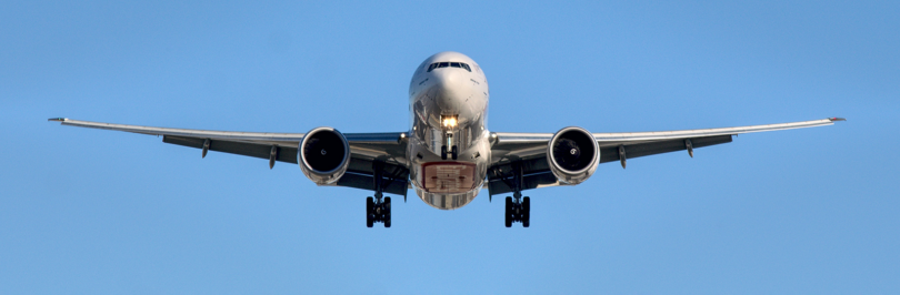 Airplane flying in midair with clear skies