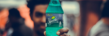 Person holding green sprite bottle