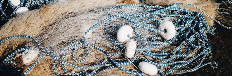 White and brown plastic fishing nets on shore