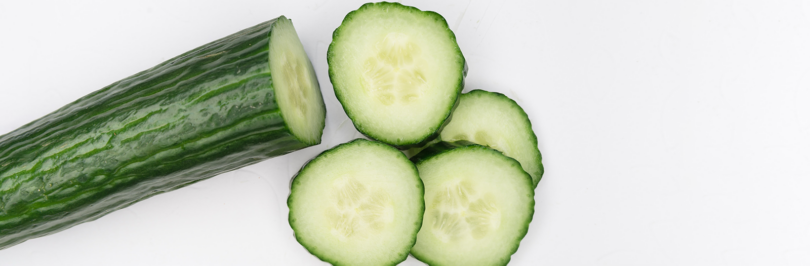 cut cucumber slices on white background