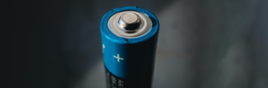 A close-up of the top of an AA battery