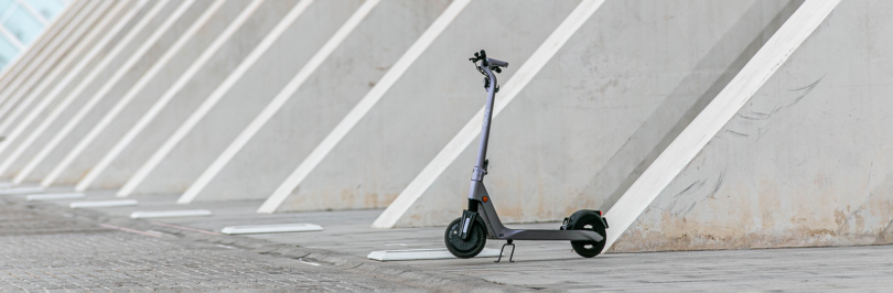 Electric scooter parked in front of building