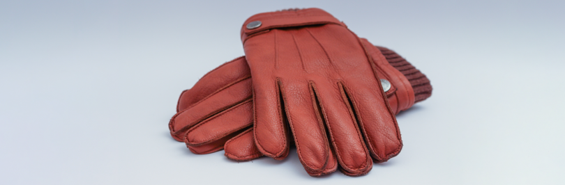 Pair of red gloves on white background