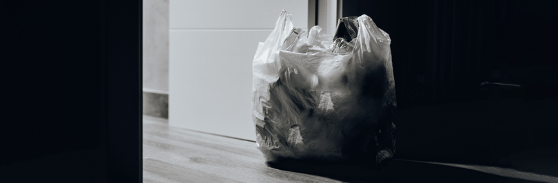 Plastic grocery bag near doorway