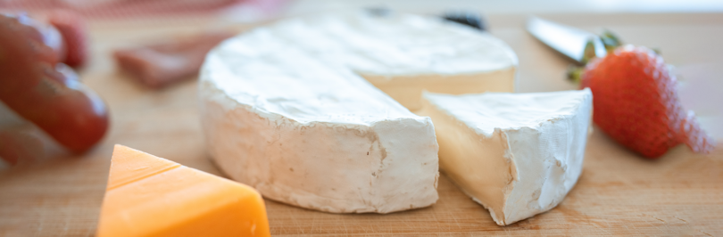 Brie cheese on cutting board