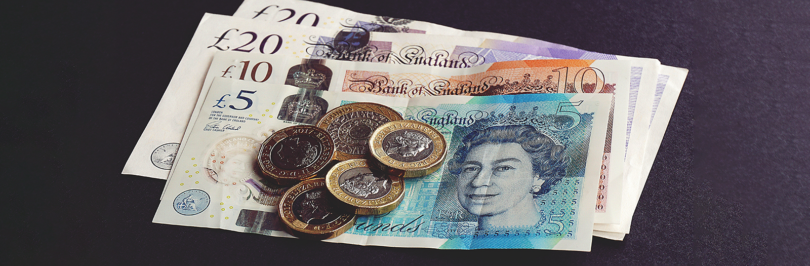 British pounds on black background