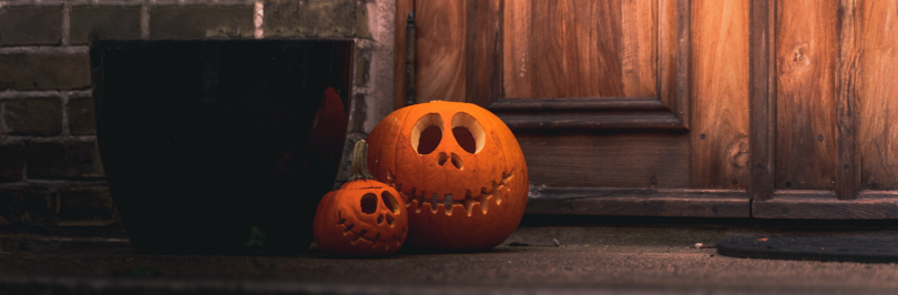 Two carved pumpkins on doorstep