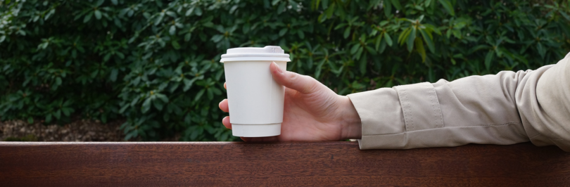 person holding paper cup