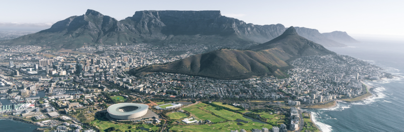 View of mountains and soccer stadium next to the ocean in cape town