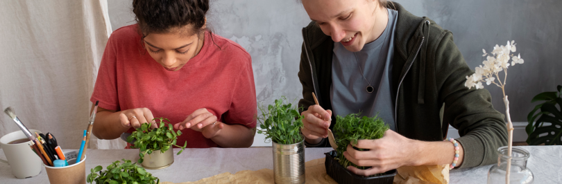 two young adults reusing paint cans